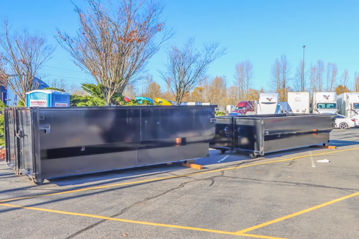 Professional dumpster rental service with roll-off container on residential driveway in Malta